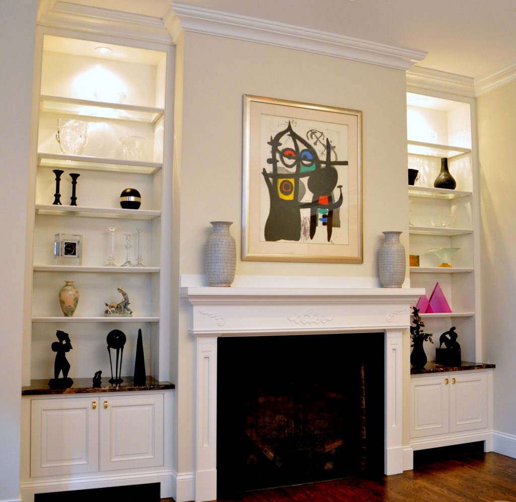 Matching cabinets make the best use of the alcoves flanking the fireplace in this Brookline condo.