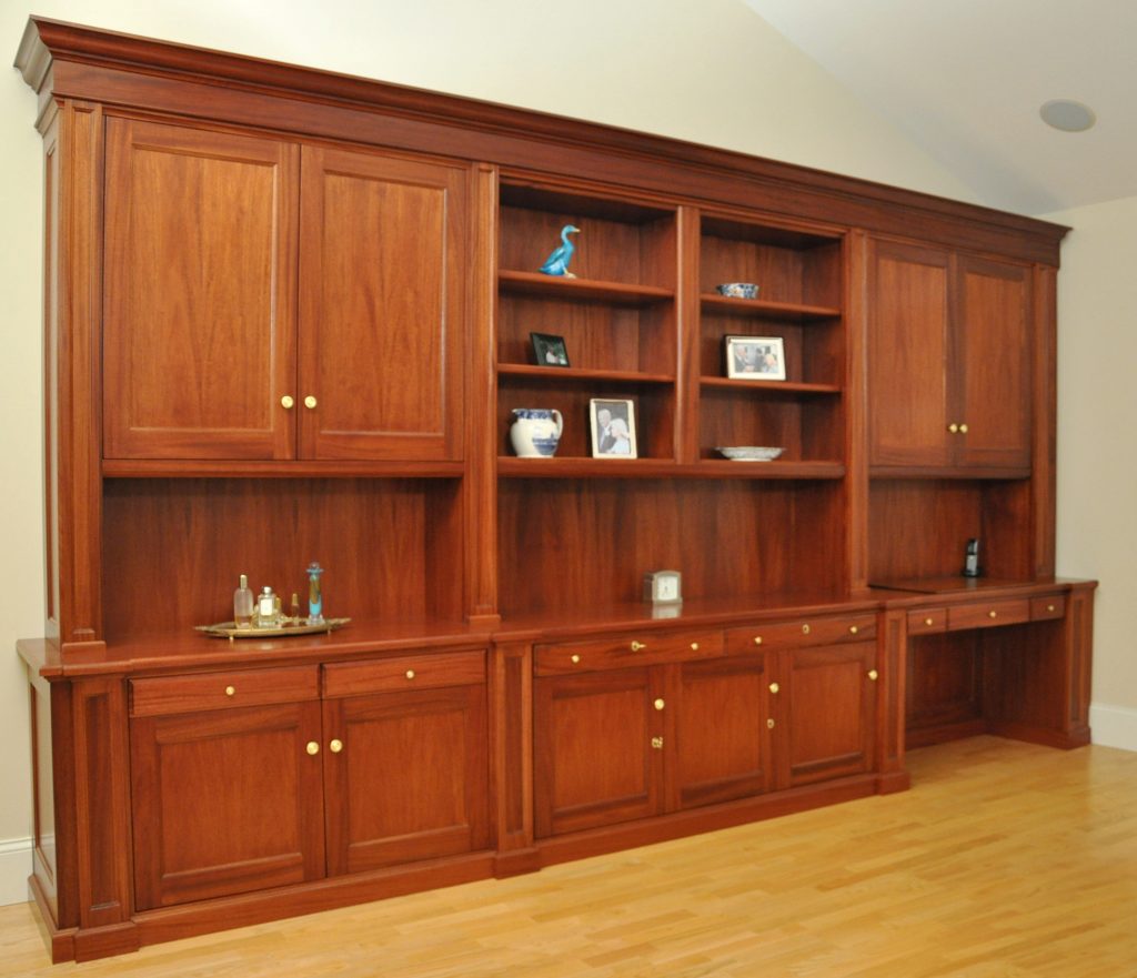 This Mahogany Wall Unit is installed in a Master Bedroom suite high above Salem Harbor. Useful storage includes pullouts and a desk area with a keyboard pullout disguised as a pencil drawer,